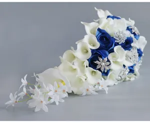 Close-up detail of the cascading wedding bridal bouquet featuring white calla lilies and blue roses.