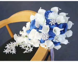 Close-up detail of a cascade wedding bridal bouquet with blue roses and white calla lilies.