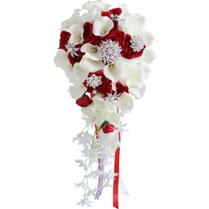 Cascading bridal wedding bouquet with red roses white calla lilies and sparkling rhinestones