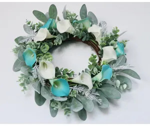 Dettaglio ghirlanda di calla artificiali, foglie di eucalipto per decorazione porta primaverile.