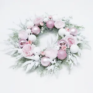 Pink Christmas wreath with artificial roses and glitter baubles for holiday door wall decor.