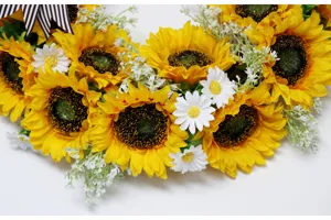 Kunstmatige zonnebloemkrans met witte margrietjes en strik voor herfst en huisdecoratie.