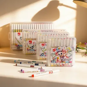 Detailed view of colorful acrylic marker sets in various sizes with loose pens on table.