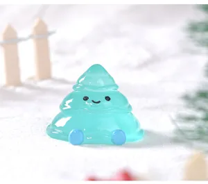 Close-up detail of a cute luminous melting Christmas tree resin miniature ornament for snow scene.