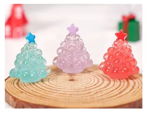 Close-up of miniature resin Christmas tree ornaments with bubble design and star top.