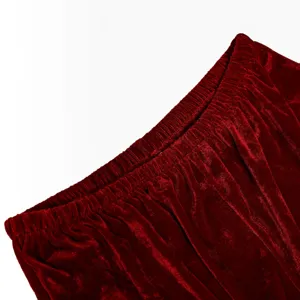 Close up detail view of the red velvet Christmas costume fabric and elastic waistband.