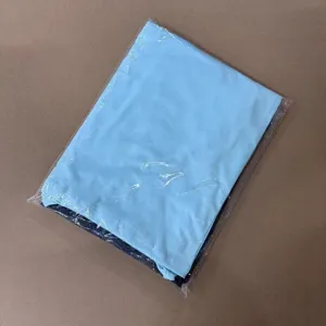 Detailed view of folded apparel clothing packed in clear protective bag for safe shipping.