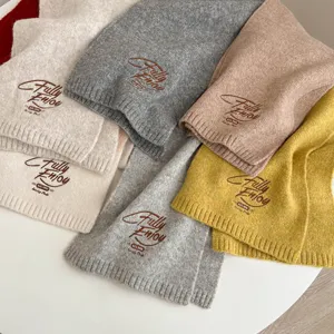 Cozy knitted winter scarf for women, featuring chic embroidered English text and warm thick design.