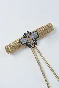 Gold metallic strap detail with embroidered bee patch for women stockings and apparel accessories.