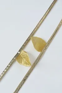 Gold metallic straps and leaf charms set for apparel decoration and costume accessories.