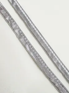 Detailed view of shiny silver metallic flat drawstring lace clothing accessory item.