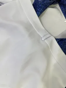 Close-up detail of cheerleader costume collar with star print and white fabric texture.