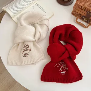 Details of the Korean style solid color knitted scarf with chic embroidery for winter warmth.