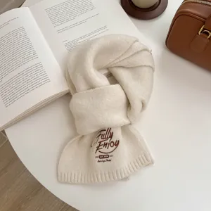 Cozy winter knitted scarf in solid off-white color with chic brown embroidery detail.