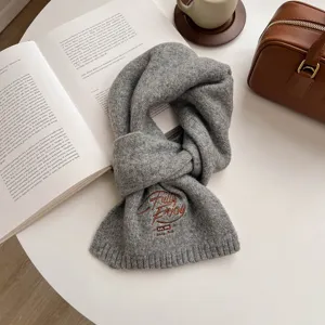 Grey knitted thick warm winter scarf for women featuring elegant English embroidery details.
