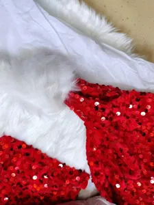 Close-up view of red sequin and fluffy white faux fur Christmas costume detail fabric.
