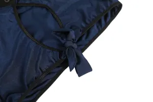 Blue roleplay costume detail shot, featuring black trim, button and a cute fabric bow.