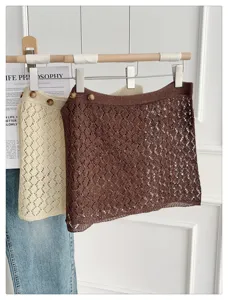 Detail view of hollow out knit layering waist skirt, elegant texture and nice button design.