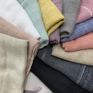 Detailed closeup shot of lightweight cotton linen scarves featuring elegant lace trim details.
