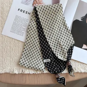 Close-up of retro knitted small scarf with geometric jacquard pattern and delicate beaded ends.