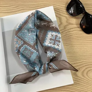 Close-up detail of a vintage blue and brown printed cotton paisley square scarf and neckerchief.