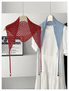 Detailed view of Korean style hollow knit triangular shawl with beaded string, soft texture.