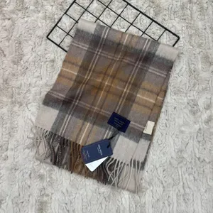Classic plaid wool scarf with fringe, warm winter neck wrap in retro brown and beige tones.