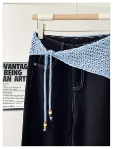 Light blue hollow knit triangular scarf with beaded drawstrings, versatile layering fashion accessory.
