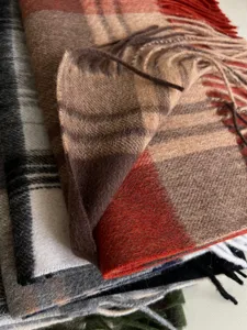 Classic plaid wool tassel scarf detail shot, warm winter cozy unisex fashion accessory.