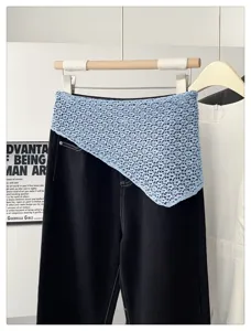 Detail view of light blue crochet knit triangular shawl, stylish decorative apparel accessory.