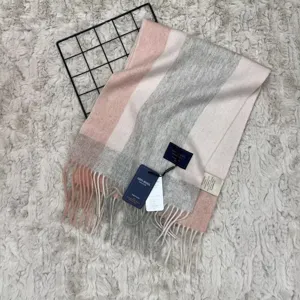 Detail view of the pink and gray striped wool scarf with soft tassels and warm texture.