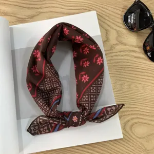 Detail shot of vintage brown floral cotton bandana scarf, elegant neck accessory for women.