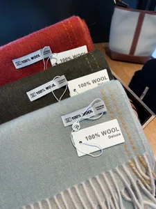 Detailed close-up view of premium wool winter scarves with elegant tassels and soft texture.