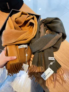 Detailed view of a cozy double-sided wool winter scarf with stylish fringe and soft texture.