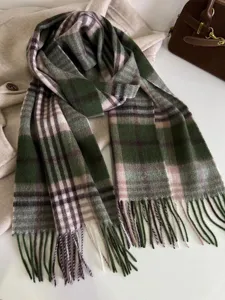 Green plaid fringe scarf detail shot, classic retro pattern wool winter warmth accessory.
