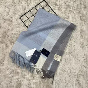 Soft blue grey plaid wool winter scarf with classic fringe detail for cozy daily wear.