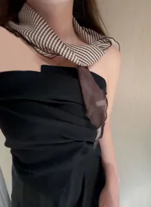 Detailed shot of a Japanese retro brown and white striped thin neck scarf, fashion accessory.