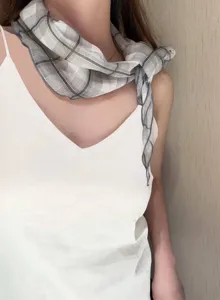 Detailed view of a Japanese vintage plaid scarf tied elegantly around the neck, lightweight.