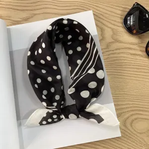 Detailed view of the Japanese retro black and white polka dot cotton scarf flat lay scene.