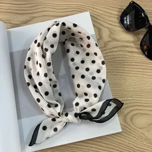 Detail shot of vintage Japanese style polka dot cotton head scarf with chic black trim.