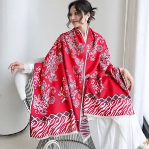 Detail shot of the red paisley pattern imitation cashmere shawl for women autumn winter wear.