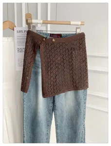 Korean style hollow knit strap layering half skirt paired with jeans for spring and summer fashion.