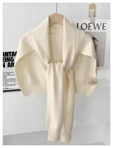 Chic knitted shawl cape with cable knit texture, warm wool blend scarf for autumn winter style.