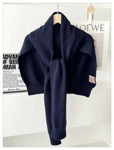 Detailed view of navy blue knitwear shawl, cozy wool blend wrap scarf for winter styling.