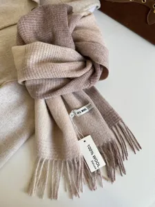 Cozy gradient wool scarf for women with elegant tassels, warm winter fashion accessory.