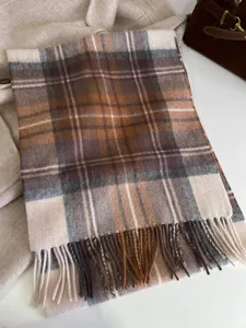 Classic retro plaid wool scarf with fringe detail, cozy winter accessory for daily wear.