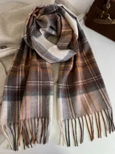 Classic retro plaid pattern scarf detail showcasing soft wool texture and elegant fringe trim.