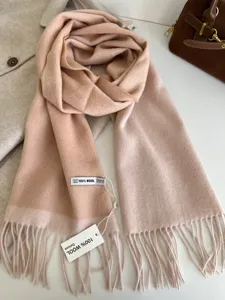 Cozy 100% wool winter scarf with dual-color design and elegant fringe detailing. Premium quality.