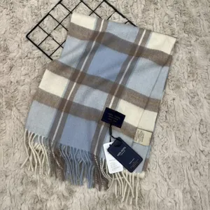 Detailed view of luxury 100% Australian wool plaid scarf with cozy fringe and classic pattern.
