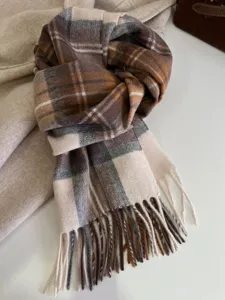 Close-up detail of the vintage classic plaid wool scarf with elegant tassels, warm design.